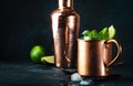 Moscow mule alcoholic cocktail in copper mug with lime, ginger beer, vodka and mint. Blue table, copper bar tools Royalty Free Stock Photo