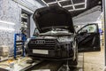 Moscow. October 2018. Decaling of the Audi Q7 with a special protective vinyl film. Germany SUV car is pulling armored film