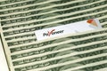 Payoneer prepaid plastic card amongst dollar bills