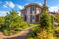 Landscape design at residential house. Beautiful landscaping with paved path in home garden. Scenic view of landscape garden in Royalty Free Stock Photo