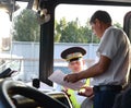 The inspector of the road police patrol checks documents from the driver of the intercity passenger bus.