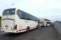 Intercity passenger buses stopped on the road.