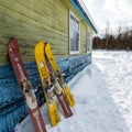 Moscow region, Russia - February 24, 2018: Two pair of old fashioned wooden skis standing near old house on white snow