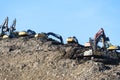 MOSCOW REGION, RUSSIA, MARCH 26, 2020. A group of working excavators on a training ground against a blue sky