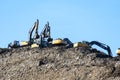 MOSCOW REGION, RUSSIA, MARCH 26, 2020. A group of working excavators on a training ground against a blue sky