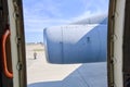 Moscow regional. Airport Chkalovsky, 12 August, 2018: Opened door of cargo aircraft with view on engine turbine, airfield at backg