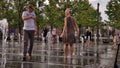 Moscow, RF Sept, 01 2019: Street photo. A couple of people having fun in the city fountain. A woman frolics in the jets of water,