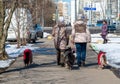 Moscow, Russia - Apr 04. 2017. Two women lead four dogs around the city on leashes
