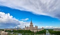 Aerial panoramic view of sunny campus buildings of famous Moscow university under dramatic cloudy sky in spring Royalty Free Stock Photo