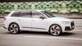 Audi Q7 SUV rushing on the highway. White Audi Q7 car moving on the street Royalty Free Stock Photo