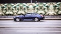 BMW M6 F13 coupe riding on the highway. Side view of shiny blue bmw 6 series driving in the street Royalty Free Stock Photo