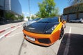 Moscow, Russia - April 14, 2019: bright orange Lamborghini Gallardo with carbon hood and other parts parked on the street Front