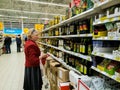 Moscow, Russia - April 14. 2018. buyer chooses olive oil in the Auchan store