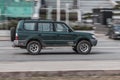 Old suv car moving at high speed on the city street. Toyota Land Cruiser Prado J90 drives fast through the city with motion blur Royalty Free Stock Photo