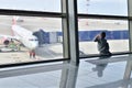 Moscow, Russia - April 4. 2018. child through window looks at plane in airport Vnukovo