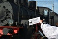 Moscow, Russia - April 1.2017. Childs hand keeps a discount ticket in Museum of History of Railway Transport Development