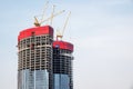 Moscow, Russia - April 13, 2021: Construction of a modern high-rise building. Construction cranes on the roof of a skyscraper Royalty Free Stock Photo