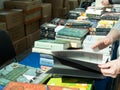 Moscow, Russia - April 6, 2023. A counter with books in English. Women\'s hands leafing through a book