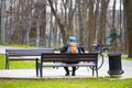 Moscow, Russia - April 18, 2023: cyclist resting in the park on a bench