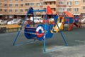 Moscow, Russia - April 5, 2020: epidemic, stop coronavirus, stay home. Children swing wrapped in red obstruction tape. Prohibition