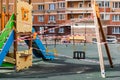 Moscow, Russia - April 5, 2020: epidemic, stop coronavirus, stay home. Playground swing prohibiting red ribbon. Prohibition of