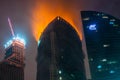 MOSCOW, RUSSIA - APRIL 02 2012: The fire on a roof of the high-rise building in the big city Royalty Free Stock Photo