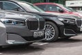 Front part of BMW 750Li with hood and radiator grill. BMW 7 Series G12 parked outdoor near business center