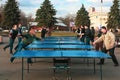 Outdoor table tennis. Group of people are playing in the park in the table tennis. People play ping pong at park Royalty Free Stock Photo