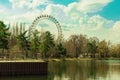 Moscow, Russia April 18 2021: Izmailovsky park pond view on big ferris wheel on nature background Royalty Free Stock Photo