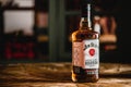 Jim Beam bourbon bottle on wooden table in bar