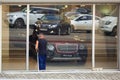 MOSCOW, RUSSIA - APRIL 17, 2018: Laborer washes the glass in a luxury car showroom in Moscow.