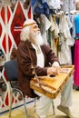 Moscow, Russia - April 12, 2023: An old man guslar plays the harp, an ancient Russian musical instrument