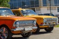 Old Soviet car Moskvich-408 and GAZ-24. Yellow car of Volga brand as a taxi