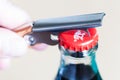 Pening a Coca-Cola glass bottle by bottle opener