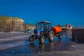 MOSCOW, RUSSIA- APRIL, 24, 2018: Outdoor view of man driving a cleaning machine washing the pavement with water after