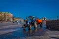 MOSCOW, RUSSIA- APRIL, 24, 2018: Outdoor view of man driving a cleaning machine washing the pavement with water after