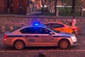 MOSCOW, RUSSIA - APRIL 30, 2018: A police car with flashing lights and a taxi near St. Basil`s Cathedral on Red Square.