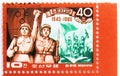 Postage stamp printed in Vietnam shows Korean and Rusian soldier with raised arms, The 40th Anniversary of Liberation serie, circa