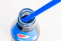 Open Pepsi drink bottle with blue drinking tube