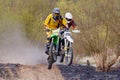 Moscow, Russia - April 13, 2019: Two racers on a motocross bikes jumps on the springboard. Training of motocross sports team Royalty Free Stock Photo