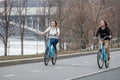 Moscow. Russia. April 9, 2019. Two young girls ride around the city on blue bicycles. Healthy lifestyle. Sports leisure.