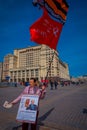 MOSCOW, RUSSIA- APRIL, 24, 2018: Unidentified woman wearing an informative sign and holding a sovietic red flag at Royalty Free Stock Photo