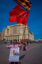 MOSCOW, RUSSIA- APRIL, 24, 2018: Unidentified woman wearing an informative sign and holding a sovietic red flag at Royalty Free Stock Photo