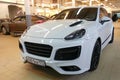 Moscow, Russia - April 19, 2019: White Porsche Cayenne in TechArt Magnum wide body kit. Stands in service center. Front side view