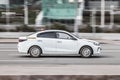 Motion city street scene with white taxi car. Fast moving white taxi cab on Moscow streets