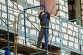 MOSCOW, RUSSIA,APRIL,29.2019:Working men on the scaffolding.Construction of a new shopping center