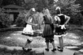 Monochrome photo. Models Three girls in elegant dresses are preparing for the perf