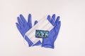 Moscow, Russia - August 01, 2020: Blue nitrile gloves, face mask and troika card for moscow metro access, travel pass, PPE