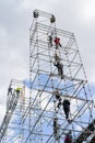 Builders assemblers assemble a high construction