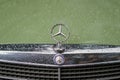 MOSCOW, RUSSIA - AUGUST 26, 2017: Close-up of Mercedes car grill and famous Star Logo, vintage green auto close-up